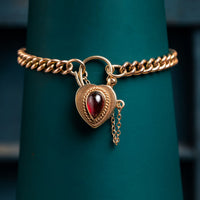 9ct rose gold curb bracelet with garnet padlock