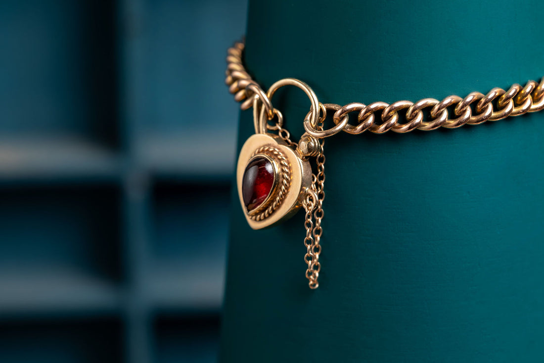 9ct rose gold curb bracelet with garnet padlock