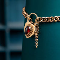 9ct rose gold curb bracelet with garnet padlock