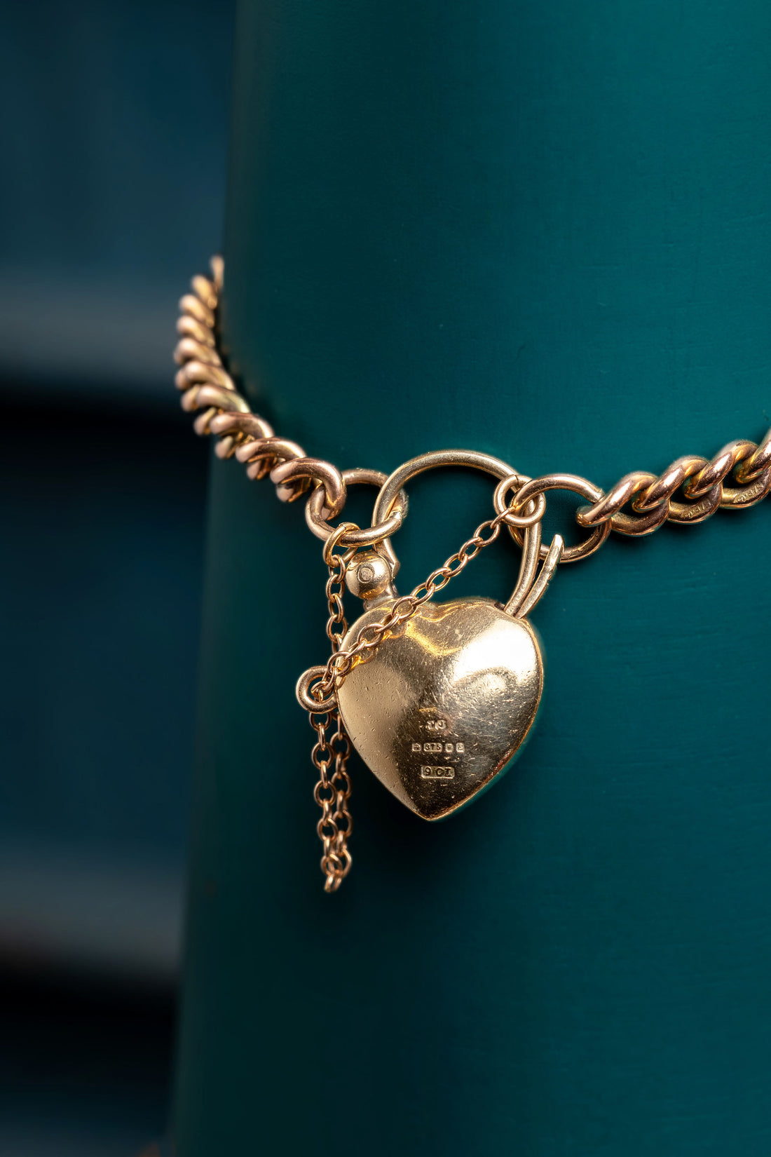9ct rose gold curb bracelet with garnet padlock