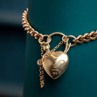 9ct rose gold curb bracelet with garnet padlock