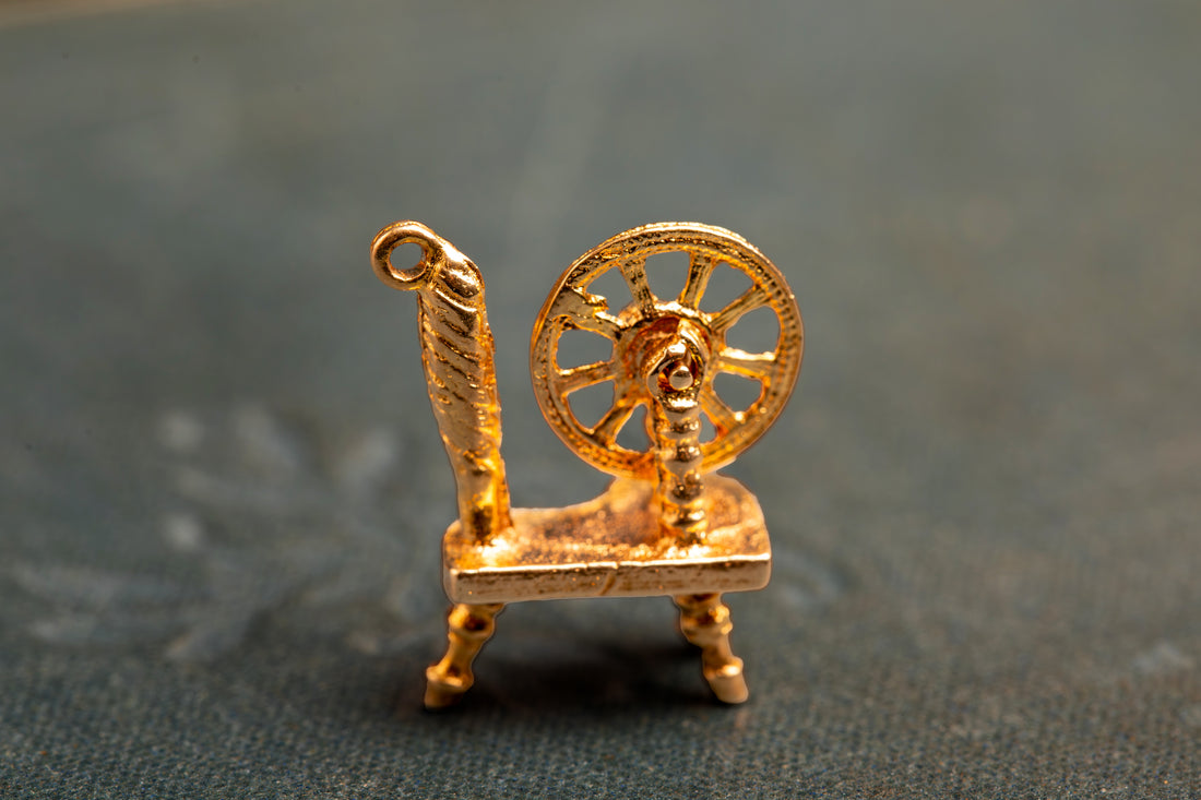 Spinning wheel charm