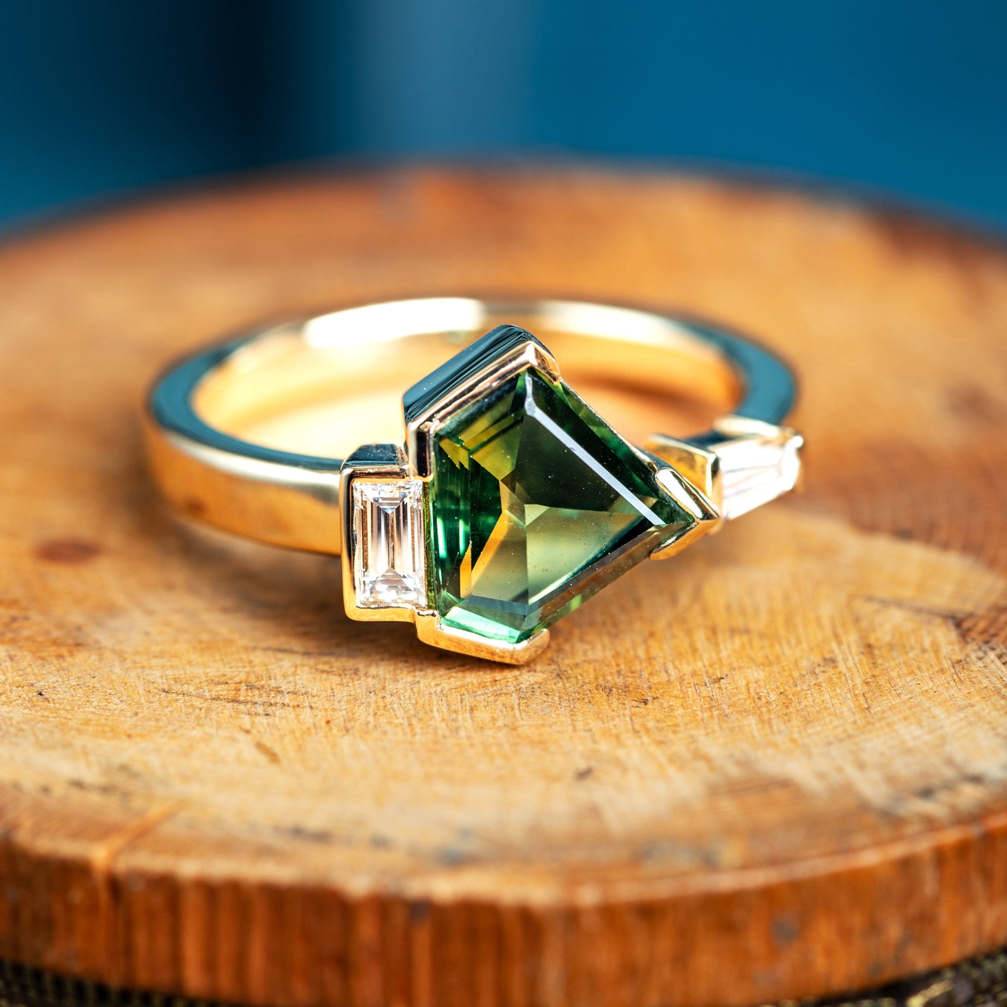 Green sapphire and baguette diamond bespoke ring in yellow gold
