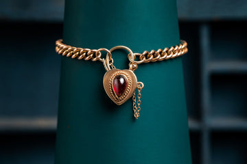 9ct rose gold curb bracelet with garnet padlock