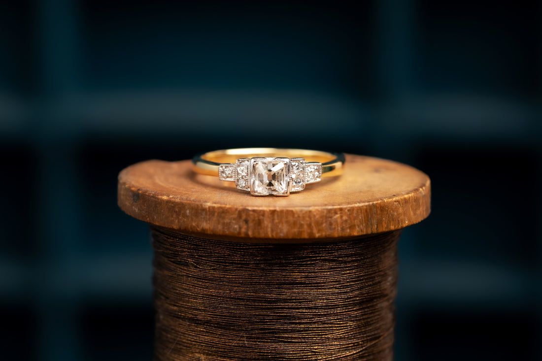 18ct and Platinum Cushion Cut Diamond Solitaire Ring with Deco Diamond Shoulders.